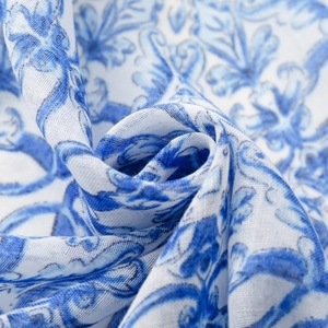 Detailed close-up of blue and white floral pattern on a lightweight voile scarf fabric
