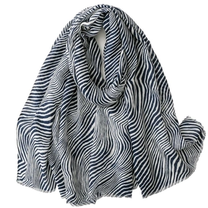 Blue and white wave striped cotton scarf with fringe trim on a clean white background