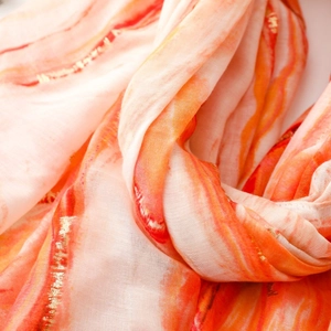 Close-up of cotton linen scarf featuring gold foil stripes and watercolor texture