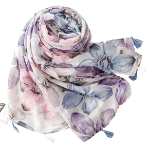 Floral print scarf in blue and purple with tassels on a white background