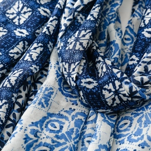 Detailed view of blue and white geometric floral print on cotton linen scarf with soft texture