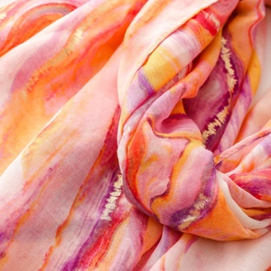 Detail of pink and orange marble pattern scarf with golden foil texture and soft fringes