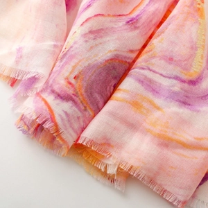 Detail of multi-color marble print scarf with fine fringe edges and soft linen texture