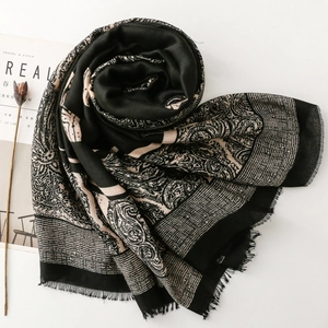 Detail of paisley and geometric pattern weave on cashmere-feel scarf with fringe edges