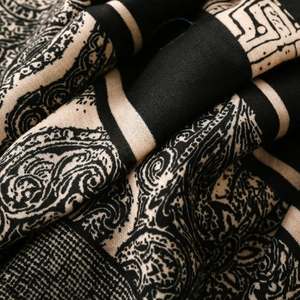 Close-up of retro paisley and geometric patterns on a thick cotton-linen feel shawl