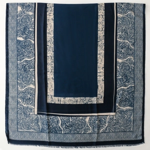 Detail of navy blue paisley print scarf with fringe edges and ethnic patterns