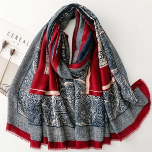 Detail view of ethnic paisley pattern scarf with soft cotton-linen texture and fringe