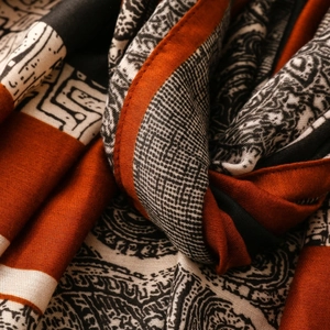 Macro view of paisley and geometric patterns on caramel blend pashmina scarf
