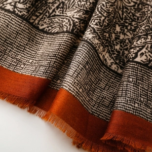Detail of paisley patterns on vintage cotton-linen scarf with caramel orange fringe trim