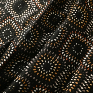 Detailed macro view of the kaleidoscope geometric print on soft cotton-linen shawl