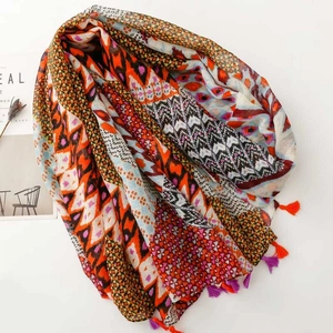 Bohemian geometric diamond pattern scarf with vibrant tassels shown from a 45-degree angle