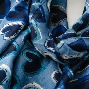 Detailed view of blue heart printed scarf with cotton-linen blend twill texture