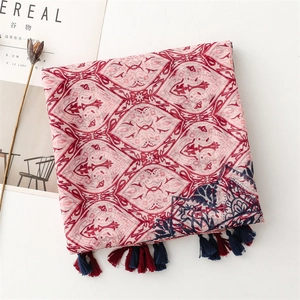 Detail of bohemian scarf showing vibrant geometric patterns and soft fringe tassels