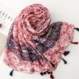 Detail of bohemian geometric print scarf with colorful fringe and lightweight texture