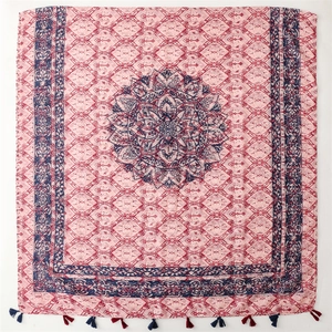 Bohemian mandala print scarf with light pink base and blue tassels on white background