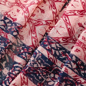 Detail of bohemian mandala print scarf with intricate colorful geometric patterns and tassels