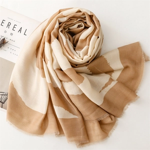 Detail of soft camel and beige wavy stripe scarf with short fringe and rich texture