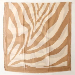 Macro shot of large square scarf featuring zebra print and delicate frayed edges