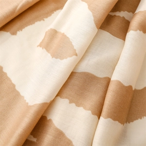 Detailed close-up of soft beige wavy textured fabric with natural woven fiber patterns
