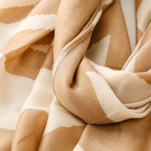 Detail shot of soft geometric striped pattern and breathable fabric on this stylish scarf
