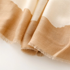 Close-up of geometric printed scarf featuring soft texture and fine fringe edge detail