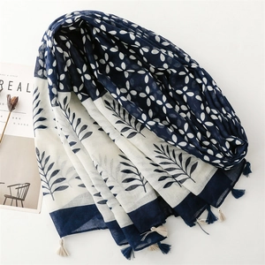 Navy blue and white floral scarf with leaf patterns and elegant tassel trim edges