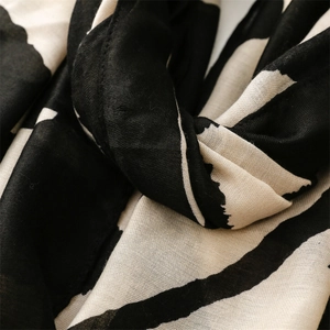 Macro detail of geometric black and white striped scarf showing fine fabric texture