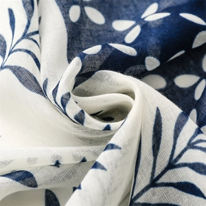 Macro detail of blue floral porcelain pattern on breathable cotton linen scarf fabric