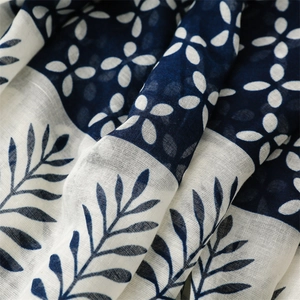 Detailed macro view of the blue and white floral pattern on soft bali yarn fabric