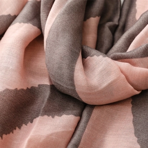 Macro shot of striped scarf texture with soft pink and coffee brown weaving detail