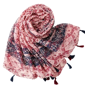 Bohemian printed scarf with geometric patterns and fringe tassels on a white background