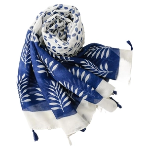 Blue and white floral print scarf with tassel edges made of lightweight fabric