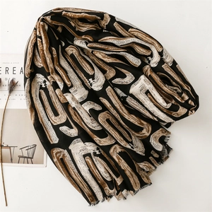Artistic geometric print scarf with abstract strokes and soft frayed edges detail
