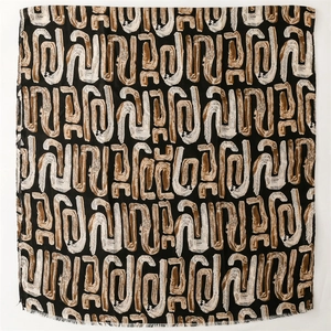 Close-up of geometric pattern and frayed edge detail on the cotton-feel pashmina