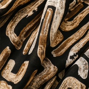 Macro detail of geometric print fabric with brushstroke patterns and woven texture