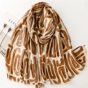 Beige cotton linen shawl with brown geometric U-shaped print and frayed fringe edge
