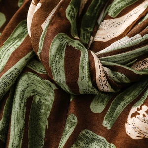 Macro detail of geometric cotton linen scarf showing abstract print and woven texture