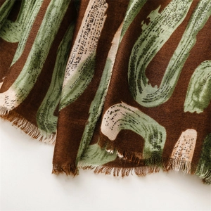 Detail shot of heavy scarf fabric with geometric print and handmade fringe tassels