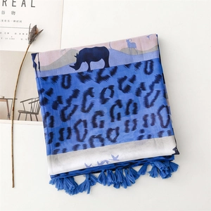 Detailed view of blue leopard rhino print scarf with decorative fringes and silky texture