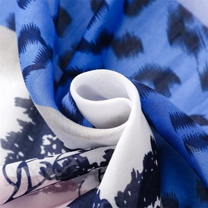 Detailed close-up of soft blue giraffe print scarf fabric with fine weave texture