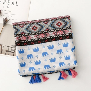Detail of soft cotton scarf featuring blue elephant prints and ethnic geometric patterns