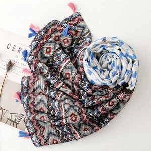 Detail of soft geometric print scarf with colorful tassels arranged in a heart shape