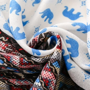 Close-up of soft cotton-linen scarf showing blue elephant and geometric patterns