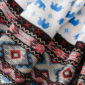 Macro detail of elephant pattern scarf showing soft cotton-linen blend fabric texture