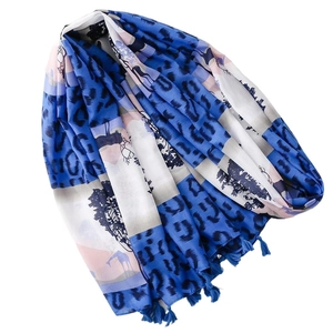 Blue animal print scarf with giraffe and leopard patterns and tassel edges