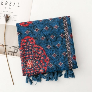 Detail of navy blue ethnic shawl with red floral patterns and delicate silk tassels