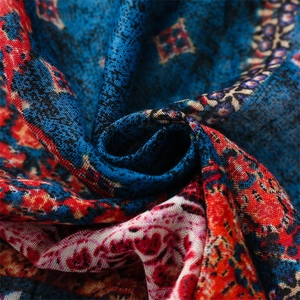 Macro view of blue and red geometric ethnic patterns on woven cotton-linen fabric scarf