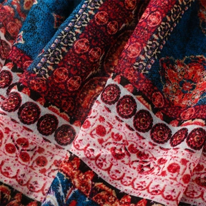 Detail of bohemian ethnic floral print on soft linen-feel scarf with geometric patterns