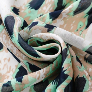 Detailed macro view of lightweight mint green leopard print scarf with soft fabric layers