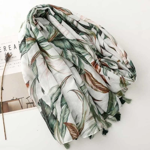 Tropical palm leaf print scarf with green tassel fringe on white background